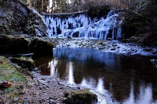 A frozen waterfall in winter. Frozen waterfall with icicles