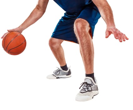 The feet of a basketball player with a ball against white studio background