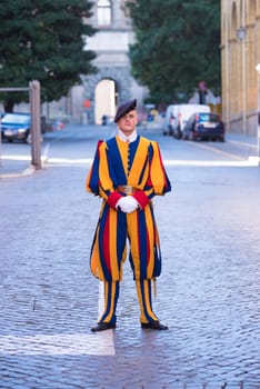 VATICAN CITY, VATICAN - OCTOBER 16, 2016: Famous Swiss Guard guarding the entrance to the Vatican City. The Papal Guard with about 100 men is the world's smallest army.