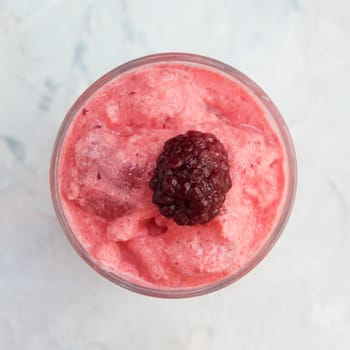 Blackberry smoothie on a white concrete background