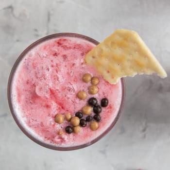 Strawberry smoothie with cookie on a white concrete background. Square cropping