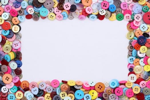 sewing buttons and threads frame on white background