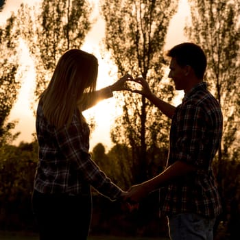 Shot of a happy couple camping on the nature and cooking