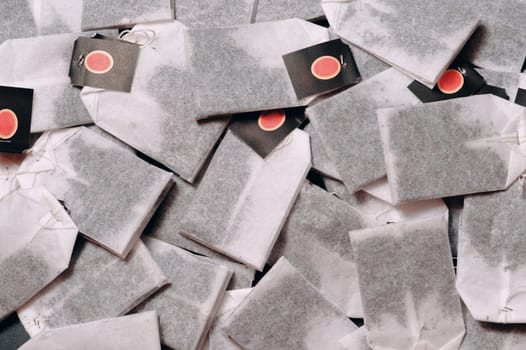 Tea bags on a dark background, stand in a row