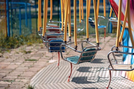 Summer playground in the park, swing carousel without people