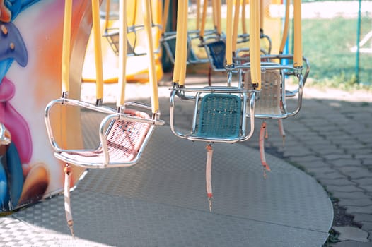 Summer playground in the park, swing carousel without people