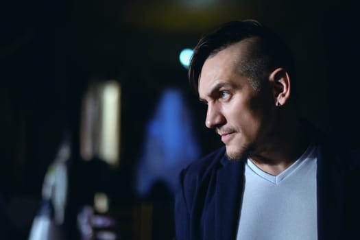 Elegant man close up portrait against dark background.