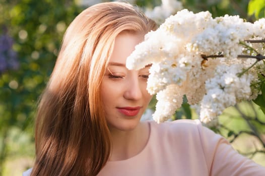 Beautiful woman with flowers of lilac. Skincare