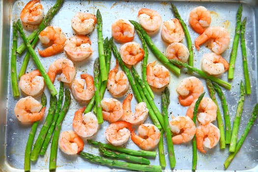 Sheet pan dinner of shrimp and asparagus with olive oil and black pepper