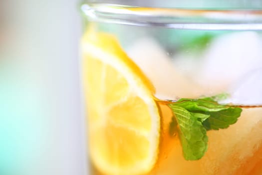Closeup of iced tea with lemon slice and mint leaves