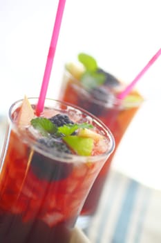 Closeup view of chilled wine cocktails with fresh apple and blackberries with mint