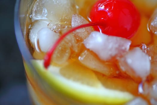 Overhead of whiskey sour over crushed ice with lemon and cherry