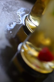 Two wine cocktails on a metal tray with pool of water with room for text