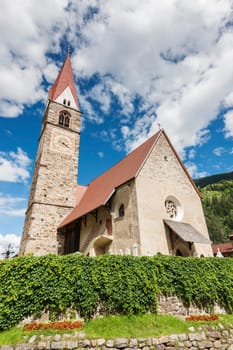 Wide-angle view of the parish church in St. Pankraz with church tower and main building in Ultental / South Tyrol in summer 2017.