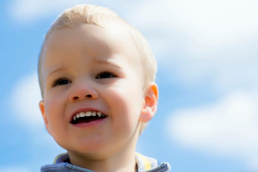 Portrait about a happy little boy with blonde hair.
