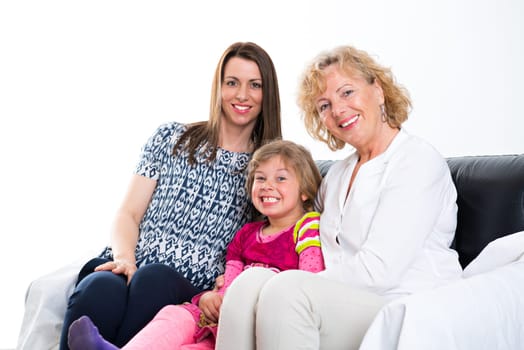 woman with daughter and grandchild together in front of white background