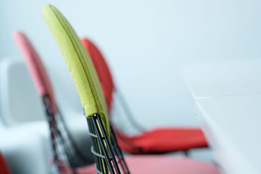 Chairs with backrest and table in a meeting room with blur