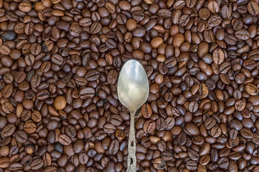 silver spoon and coffee beans as the background