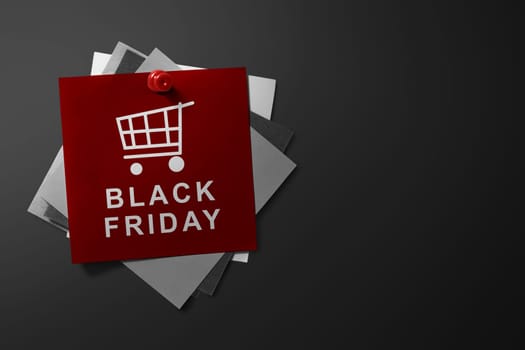 Black Friday text on red paper pinned on the wall