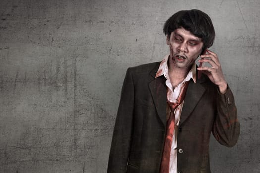 Portrait of creepy asian zombie man in suit call via cellphone