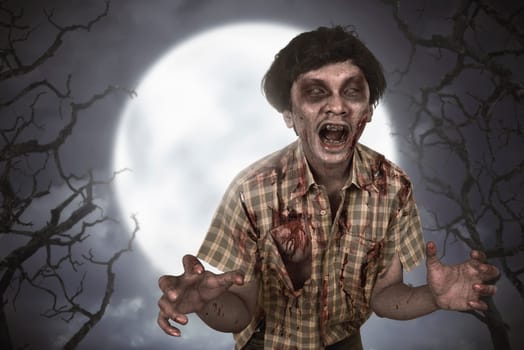 Spooky asian zombie man with bloody face standing at moonlight