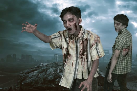 Two asian zombies with angry face walking around over dark sky background