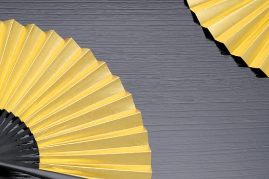 traditional chinese style golden hand fan on gray background　