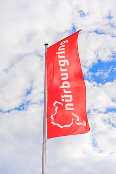 Nurburg, Germany - May 20, 2017: Flag at race track Nurburgring info center entrance, labeled with "Nurburgring"" and logo"
