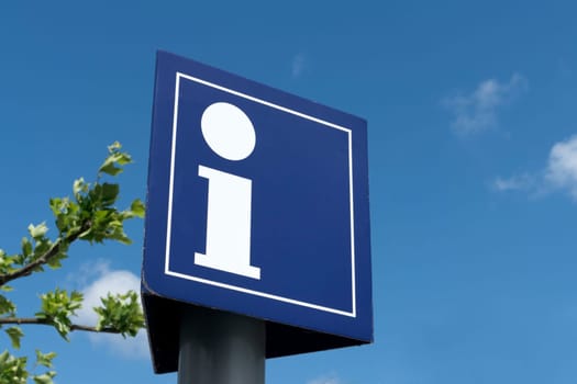 Information sign in front of a blue sky