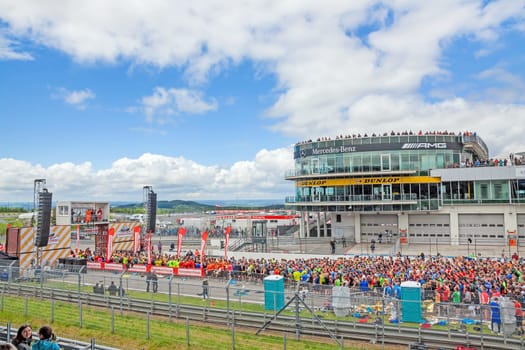 Nurburg, Germany - May 20, 2017: Fishermen's Friend Strongman RUN at race track Nurburgring - runners waiting for start on start finishing straight with stage in front of Mercedes / AMG lounge tower