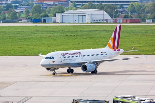 Stuttgart, Germany - May 06, 2017: Airbus A319 airplane from Germanwings / Lufthansa Group at ground (airport Stuttgart) on its way to parking position - green meadow and hangar in background