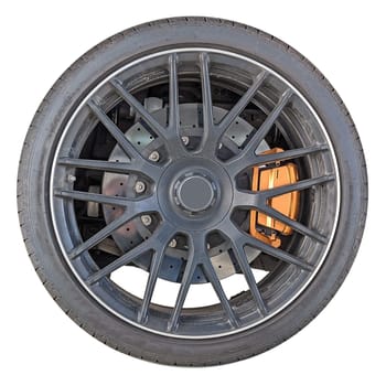 wheel rim with tire of sports car isolated on white background