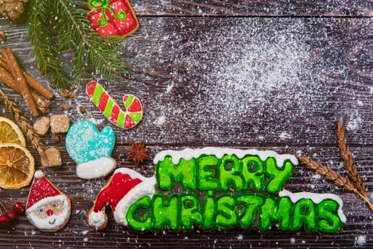 Gingerbreads for new years and christmas on wooden background, xmas theme