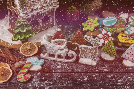 Gingerbreads for new years and christmas on wooden background, xmas theme