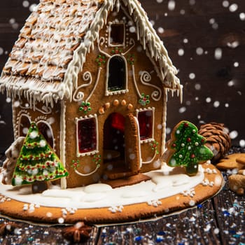 Gingerbread house with lights on dark background, xmas theme