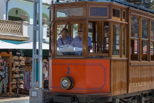 Port De Soller, Spain - June 02, 2016: Vintage train, tram on the beach promenade of the town of Soller in Spain. Opened in 1913, the driving distance is about 5 km long.