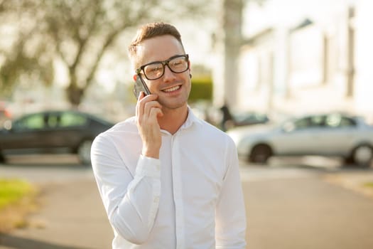 Man with glasses speak on mobile phone, In City, Urban Space, Park