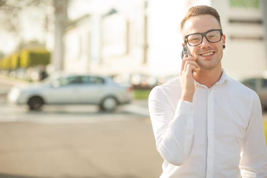 Man with glasses speak on mobile phone, In City, Urban Space, Park
