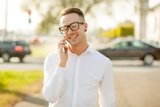 Man with glasses speak on mobile phone, In City, Urban Space, Park