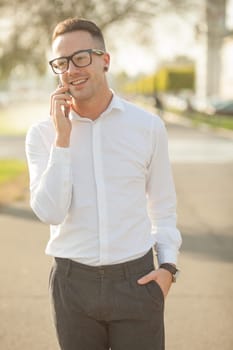Man with glasses speak on mobile phone, In City, Urban Space, Park