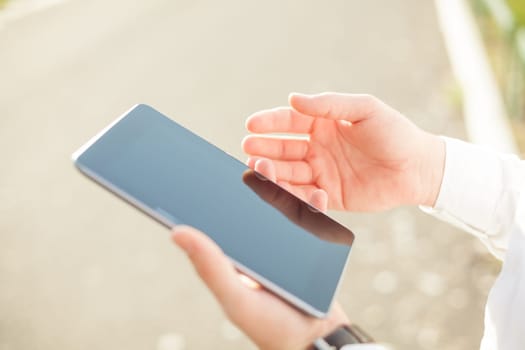 Close up of young man hands using touchscreen on digital tablet