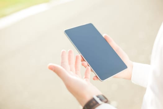 Close up of young man hands using touchscreen on digital tablet