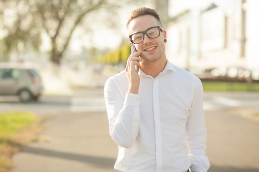 Man with glasses speak on mobile phone, In City, Urban Space, Park