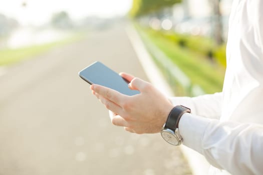 Close up of young man hands using touchscreen on digital tablet