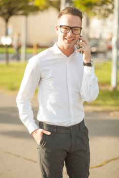 Man with glasses speak on mobile phone, In City, Urban Space, Park