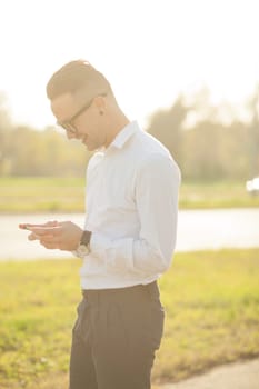 Man with glasses speak on mobile phone, In City, Urban Space, Park