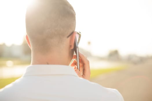 Man With Mobile Phone And Hat, In City, Urban Space, back view, outdoor