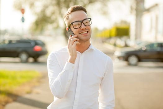 Man with glasses speak on mobile phone, In City, Urban Space, Park