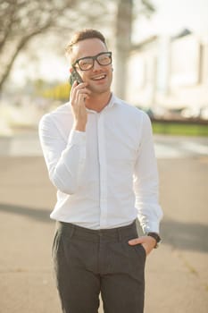 Man with glasses speak on mobile phone, In City, Urban Space, Park