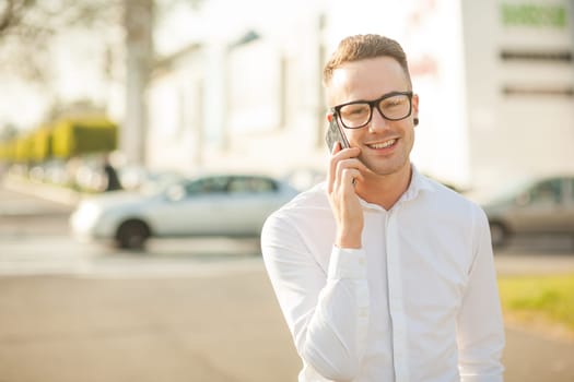 Man with glasses speak on mobile phone, In City, Urban Space, Park